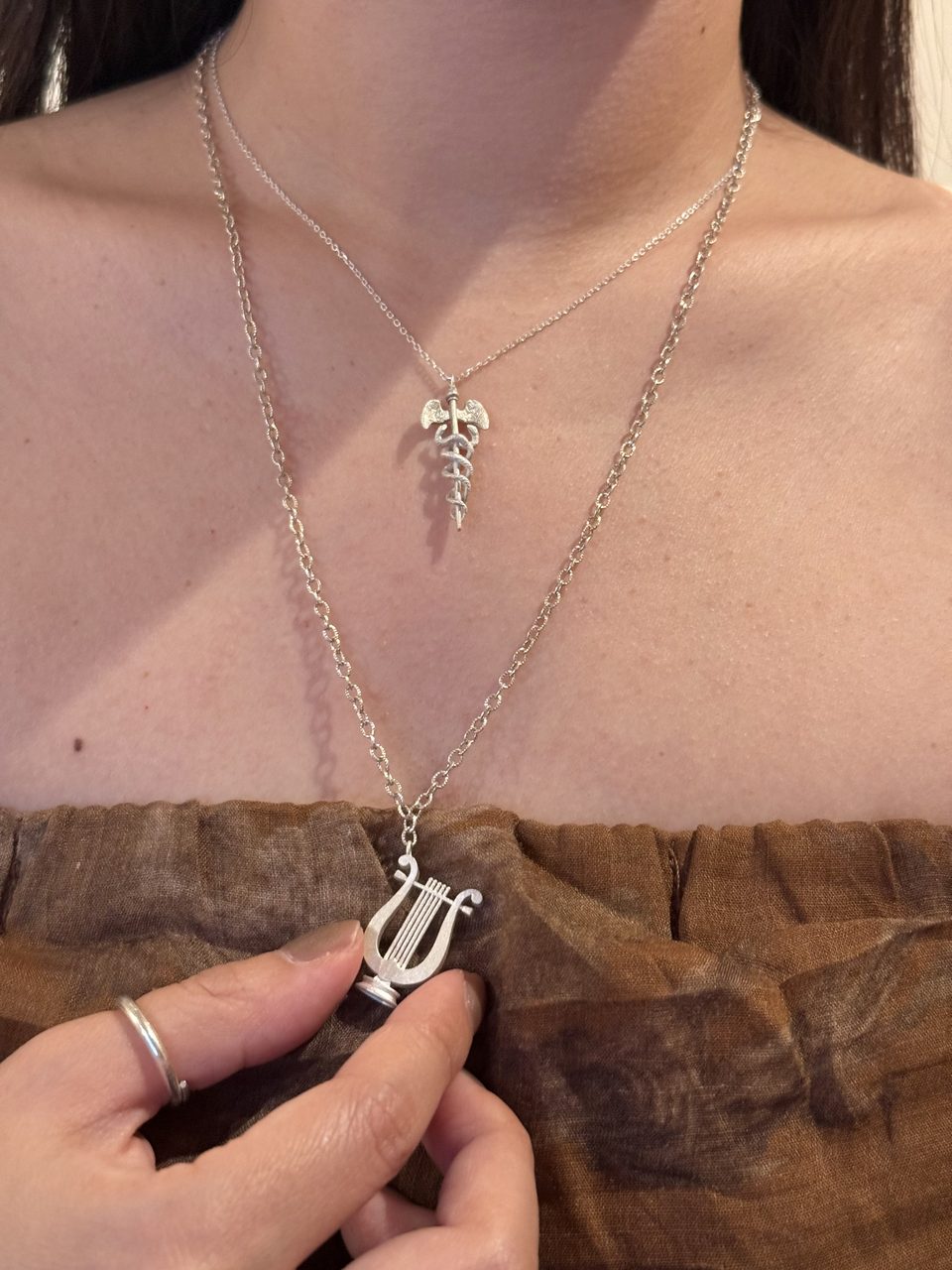 Le Fond Hermes’ Caduceus pendant, 925 silver, worn with other pieces (3)