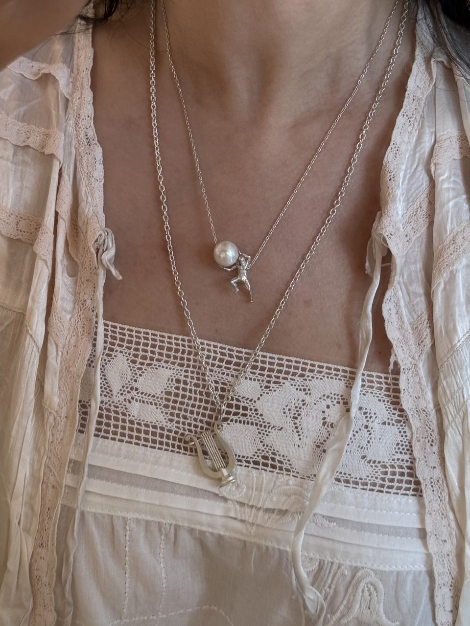 Le Fond Sisyphus pendant, 925 silver with a pearl or a silver obsidian, worn with other pieces (5)